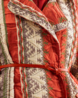Eye-catching coral jacket featuring dynamic fringed detailing