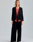 Elegant black jacket featuring subtle floral accents and chic sleeves