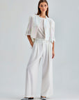 Elegant ivory trousers featuring a high waist and flowing wide-leg design