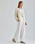 Luxurious wide-leg ivory trousers with high-rise fit and sleek concealed zipper