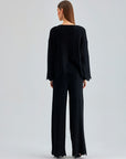 Annais Knit Set in slightly shiny black, featuring long-sleeve top with zigzag patterns and coordinated pants