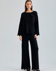 Annais Knit Set in sleek black with long-sleeve top featuring zigzag patterns and floral shoulder embellishments