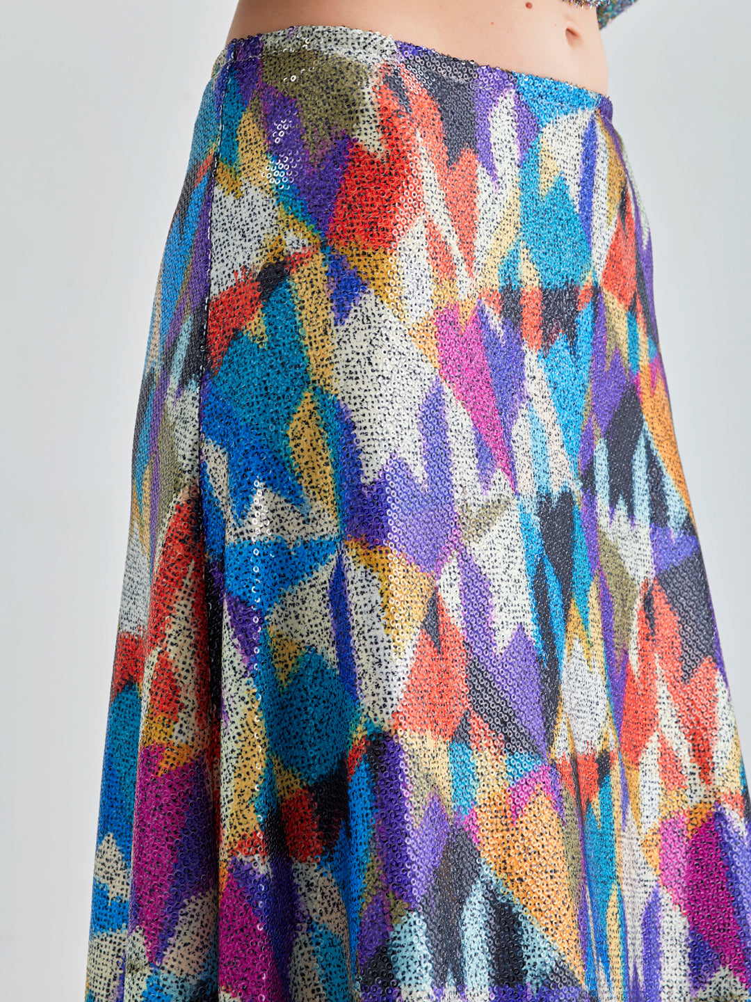 Cora Skirt with bold geometric patterns in cool blues and purples, showcasing a dynamic visual impact