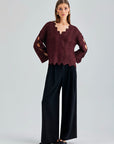 Ernesta Sweater Bordeaux in rich red with avant-garde asymmetrical cut-outs climbing the sleeves