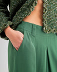 Elegant green high-rise trousers with pleated detailing and wide-leg design