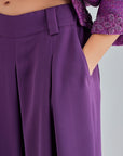 Elegant high-rise violet trousers featuring pleated detailing and wide-leg silhouette