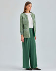 Modern green trousers with high-rise waist and wide-leg flow