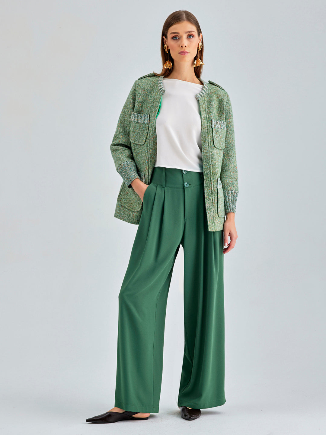 Sophisticated green wide-leg pants with tailored button-fastened waistband and belt loops