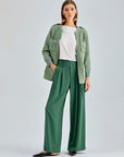 Sophisticated green wide-leg pants with tailored button-fastened waistband and belt loops