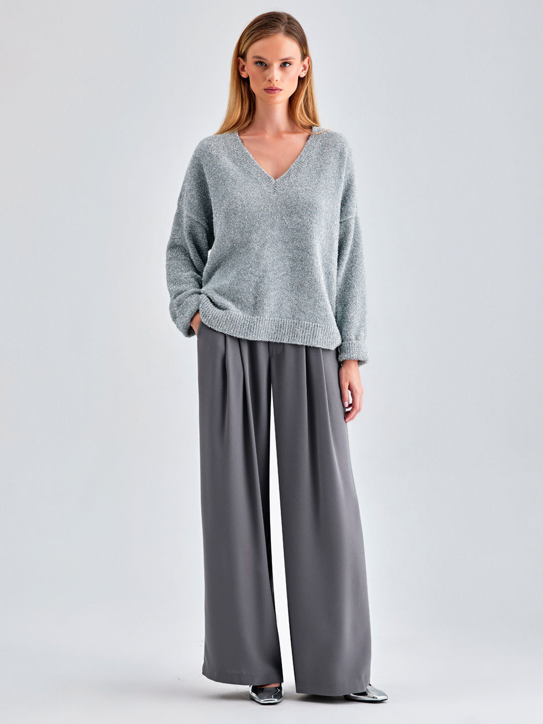 Classic Kate Sweater in grey featuring ribbed cuffs and a V-neck design, ideal for casual and dressy wear