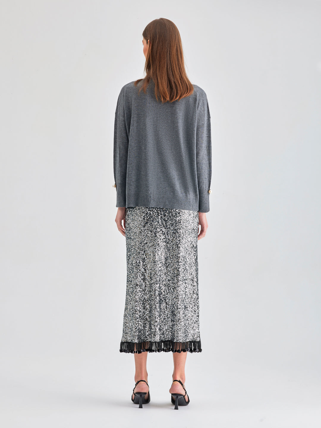 Versatile Lupita Skirt Grey with sleek finish and textured fringe at hem