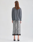 Versatile Lupita Skirt Grey with sleek finish and textured fringe at hem