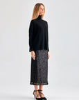 Elegant Lupita Skirt in black with playful fringe hem and subtle sheen