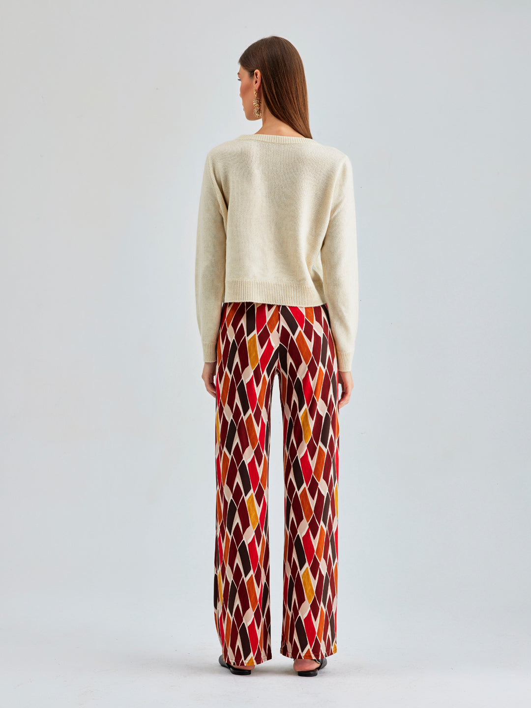 Eye-catching Pepe Pants featuring rich, warm tones and a dynamic check pattern for added flair