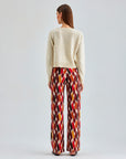 Eye-catching Pepe Pants featuring rich, warm tones and a dynamic check pattern for added flair