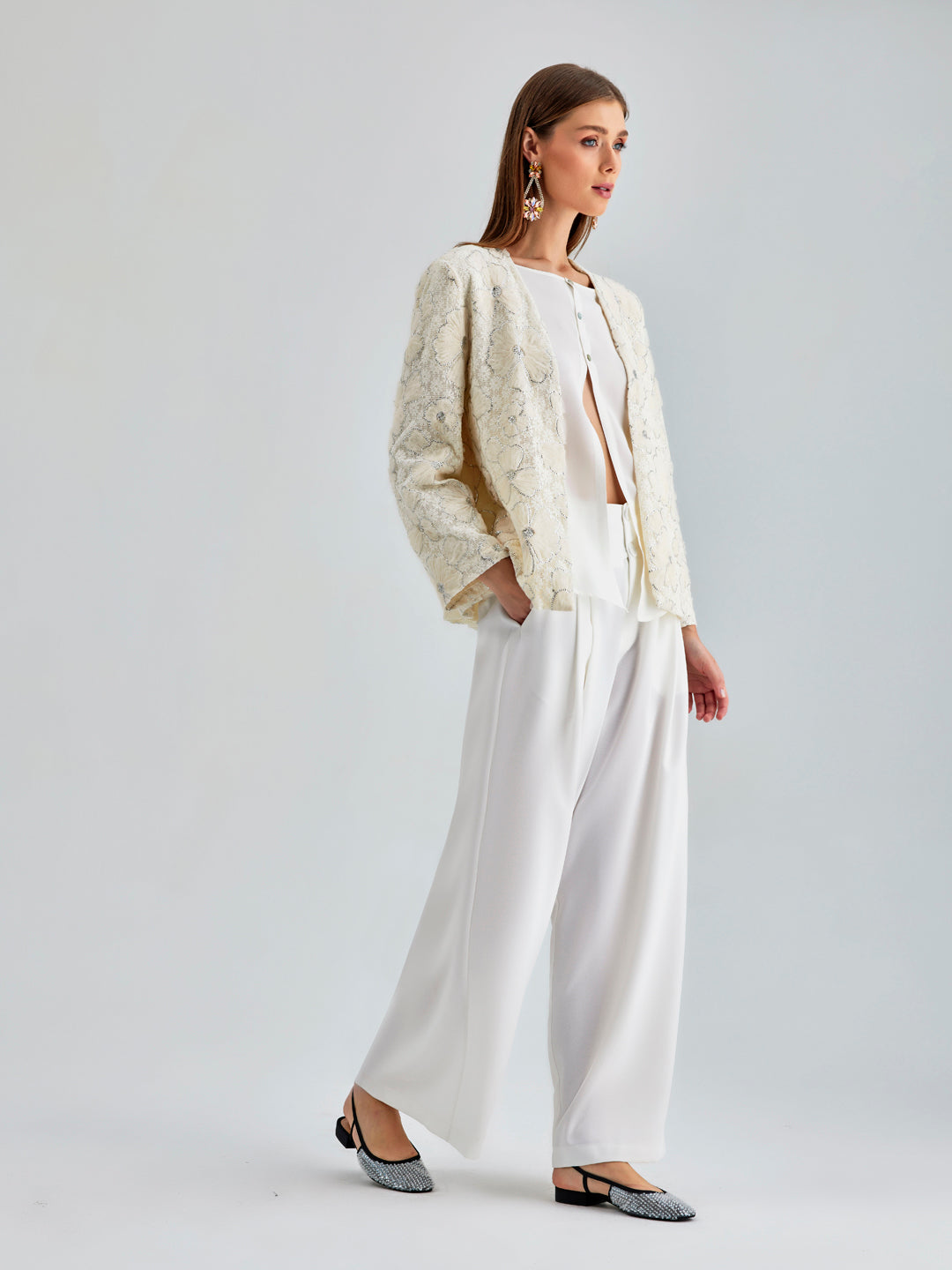 Luxurious wide-leg ivory trousers with high-rise fit and sleek concealed zipper