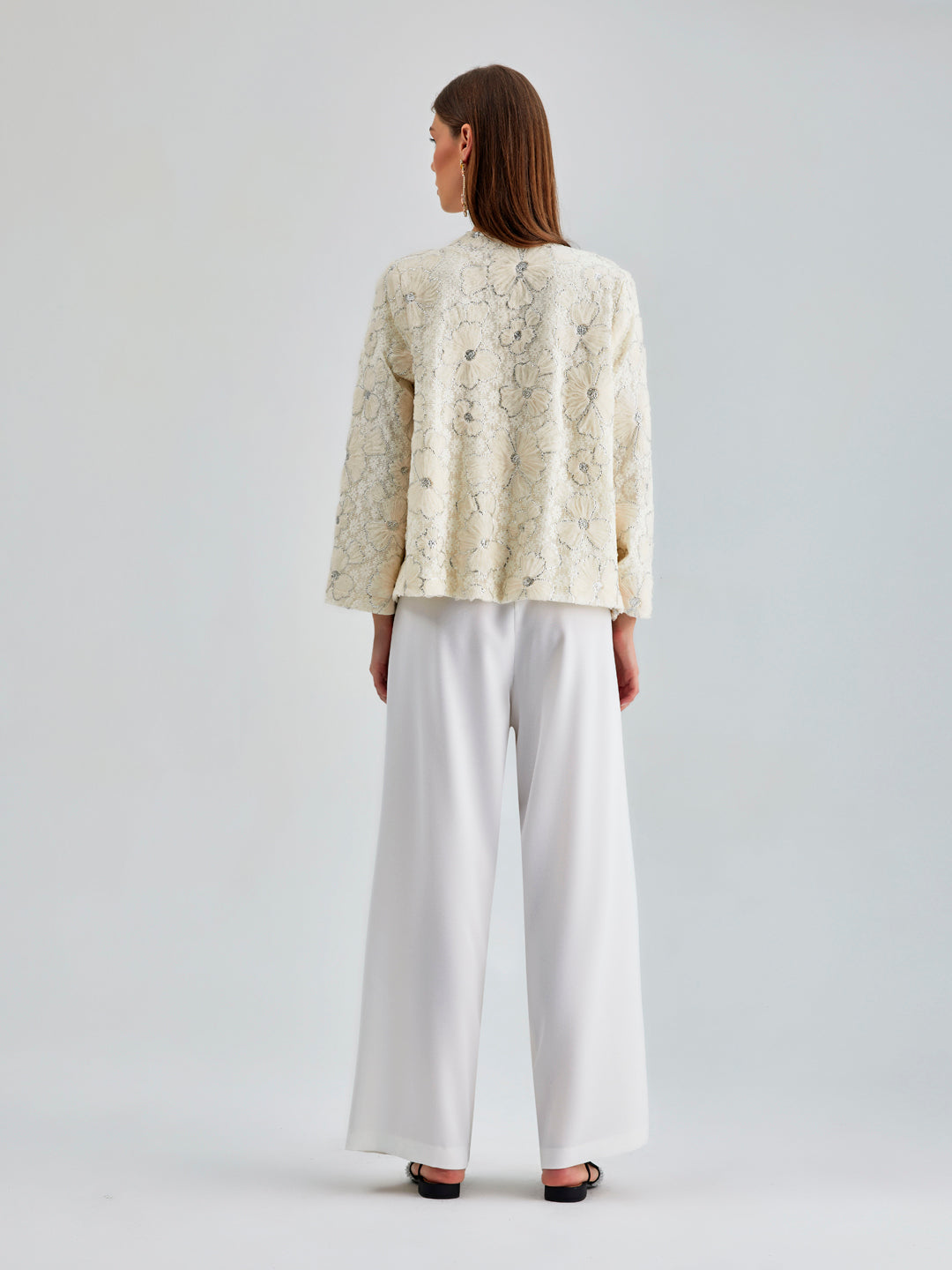 Luxurious ivory jacket with sophisticated floral accents and sleek silhouette