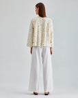 Luxurious ivory jacket with sophisticated floral accents and sleek silhouette