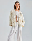 Statement-making ivory jacket with chic sleeves and elegant floral design