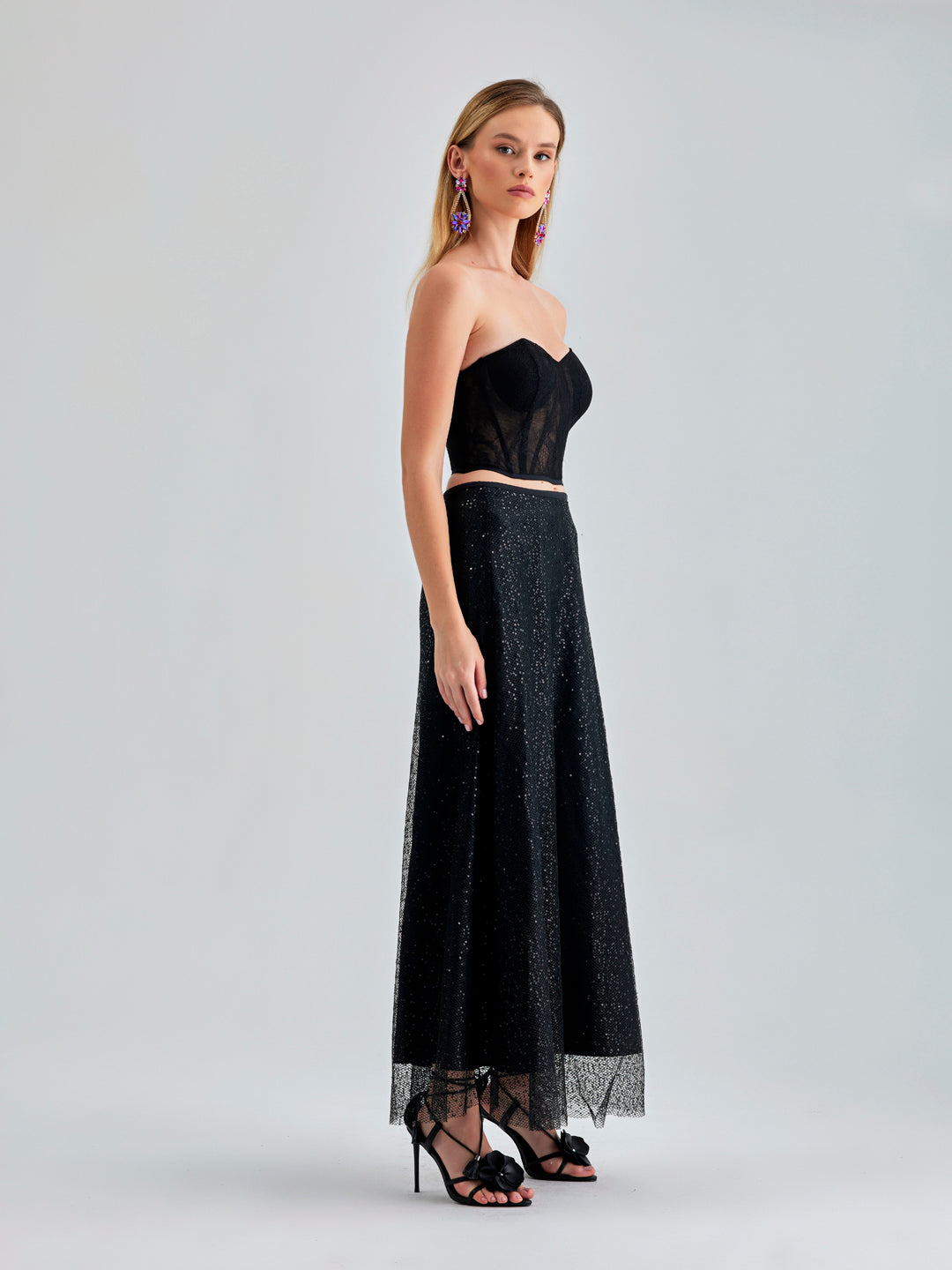 Sophisticated Vera Skirt in black featuring tulle overlay and radiant sheen