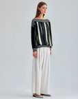 Contemporary Jadira Sweater with vertical stripes and innovative gaps, perfect for high-fashion looks