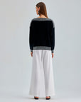 Bold Jadira Sweater with vertical stripes in black, grey, and white and avant-garde structure