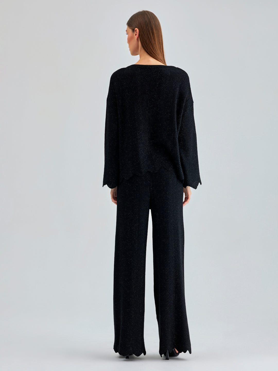 Annais Knit Set in slightly shiny black, featuring long-sleeve top with zigzag patterns and coordinated pants