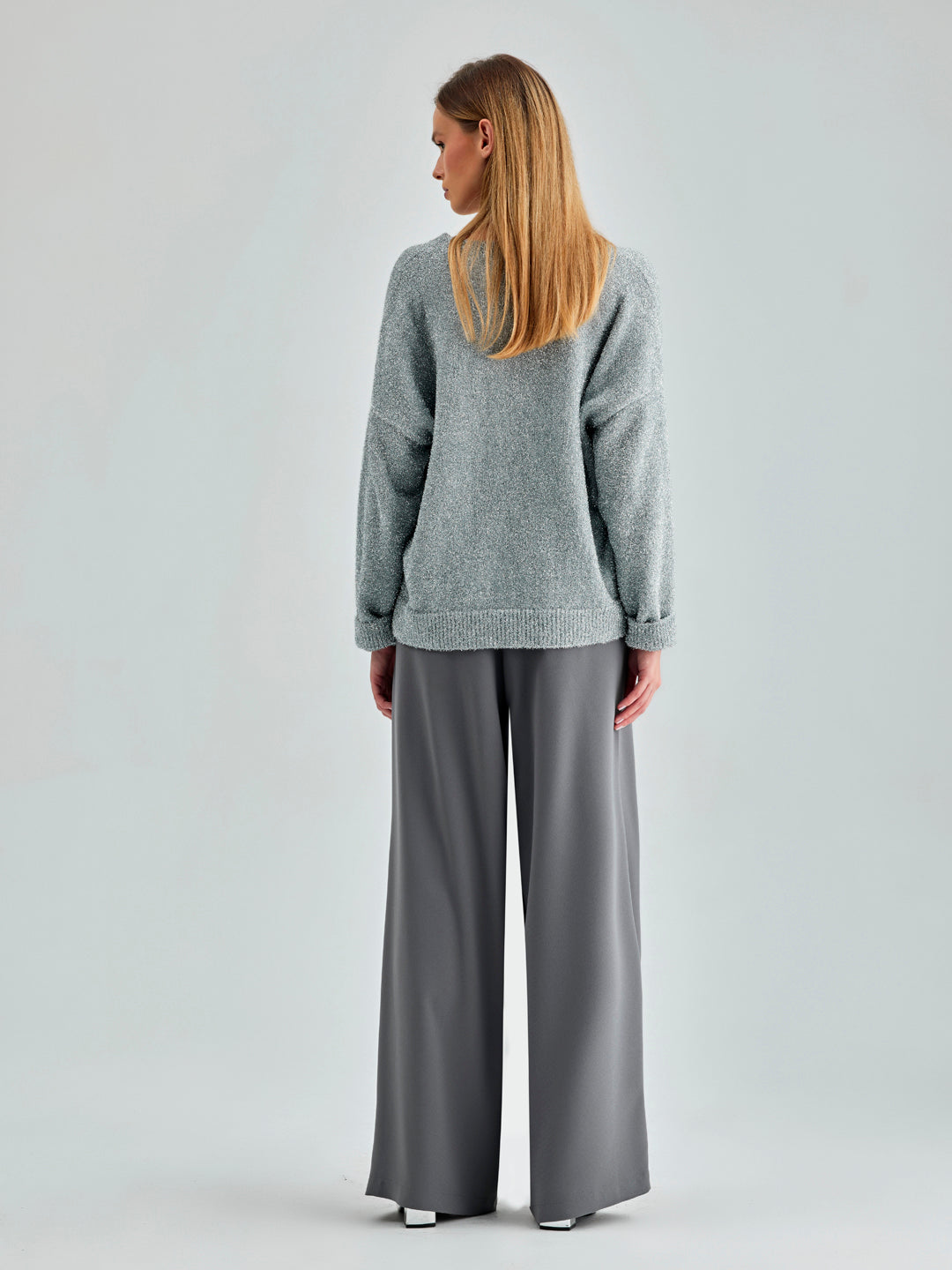 Modern grey trousers with button-fastened waist and versatile styling options