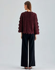 Fashion-forward Ernesta Sweater Bordeaux featuring bold sleeve details and innovative architectural collar