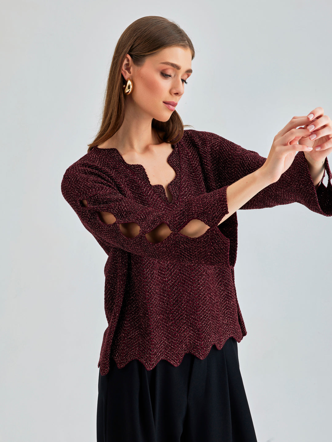 Elegant Ernesta Sweater in deep red featuring unique cut-out details and architectural ladder collar