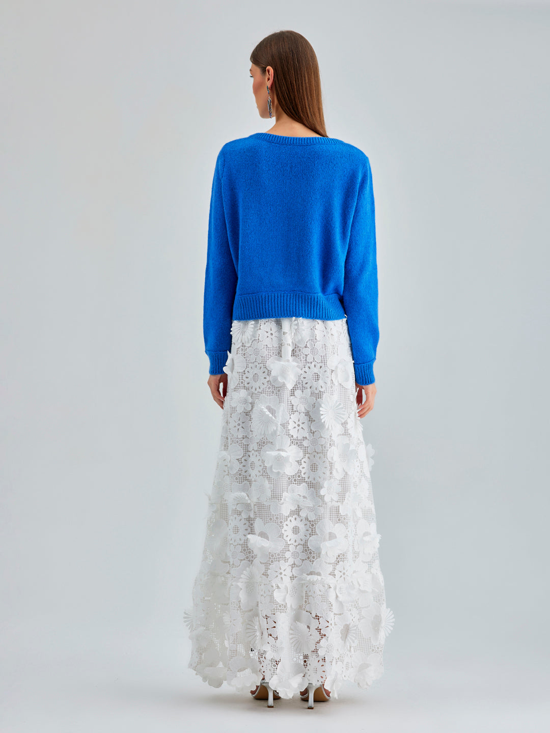 Daisy Cardigan Blue with a soft, draping fabric and delicate embroidery, enhancing any outfit with understated charm