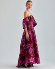 Zelene Gown Red with seductive open back and bold floral patterns, ideal for high-profile events