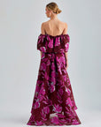 Red Zelene Gown featuring large floral patterns, low-cut shoulders, and a flowing, elegant design