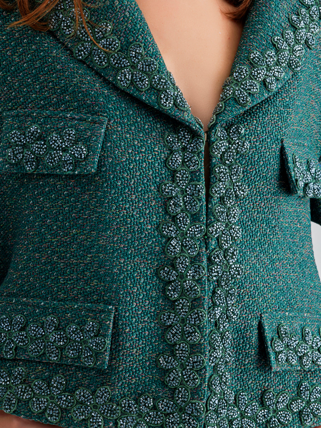 Elegant green jacket with refreshing open neckline and floral accents