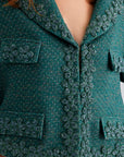 Elegant green jacket with refreshing open neckline and floral accents