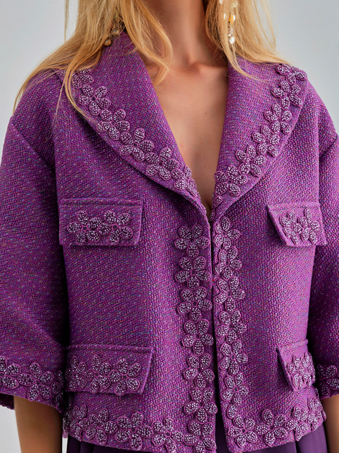 Elegant violet jacket with breezy open neckline and floral accents