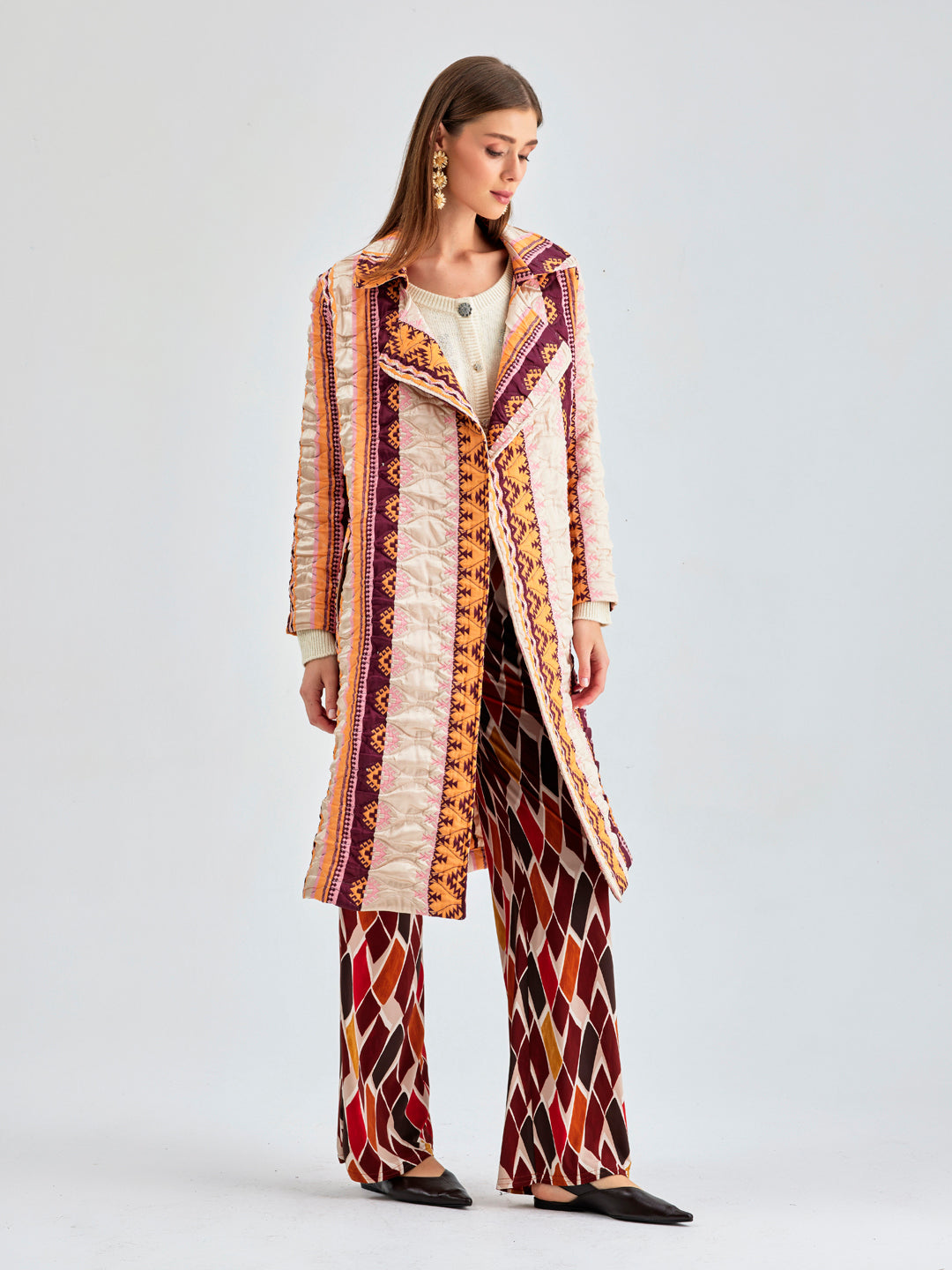 Playful and sophisticated coral jacket with distinctive fringed patterns